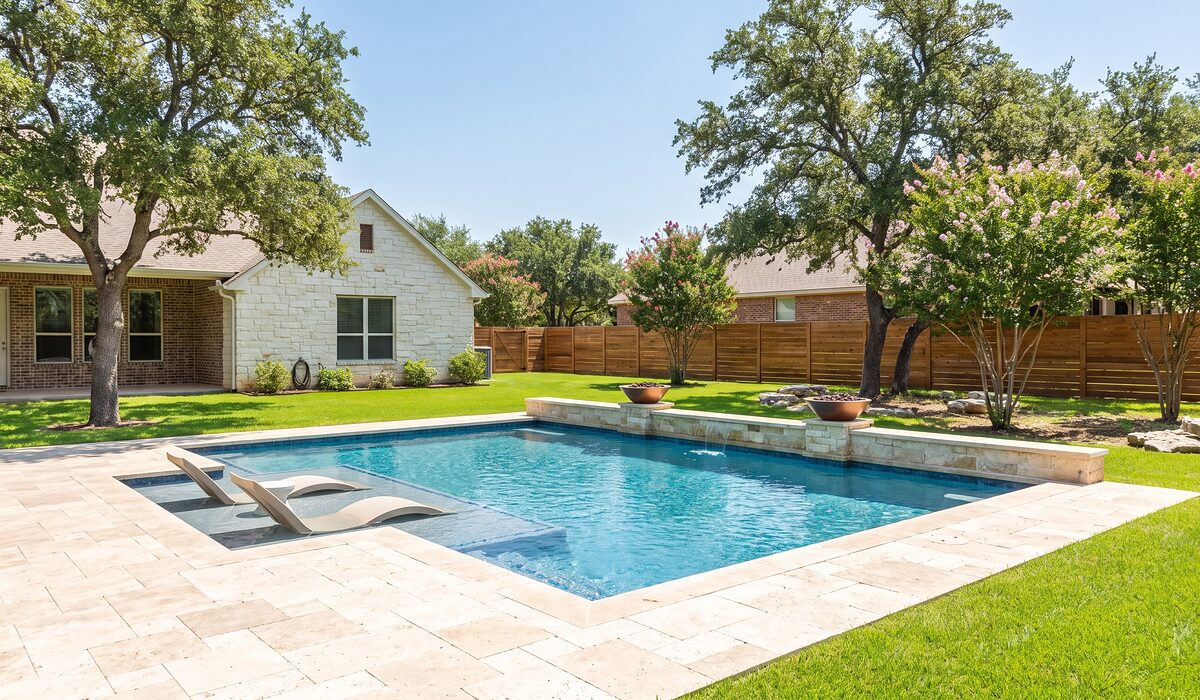 Newly built custom gunite pool with a travertine deck at a Texas home