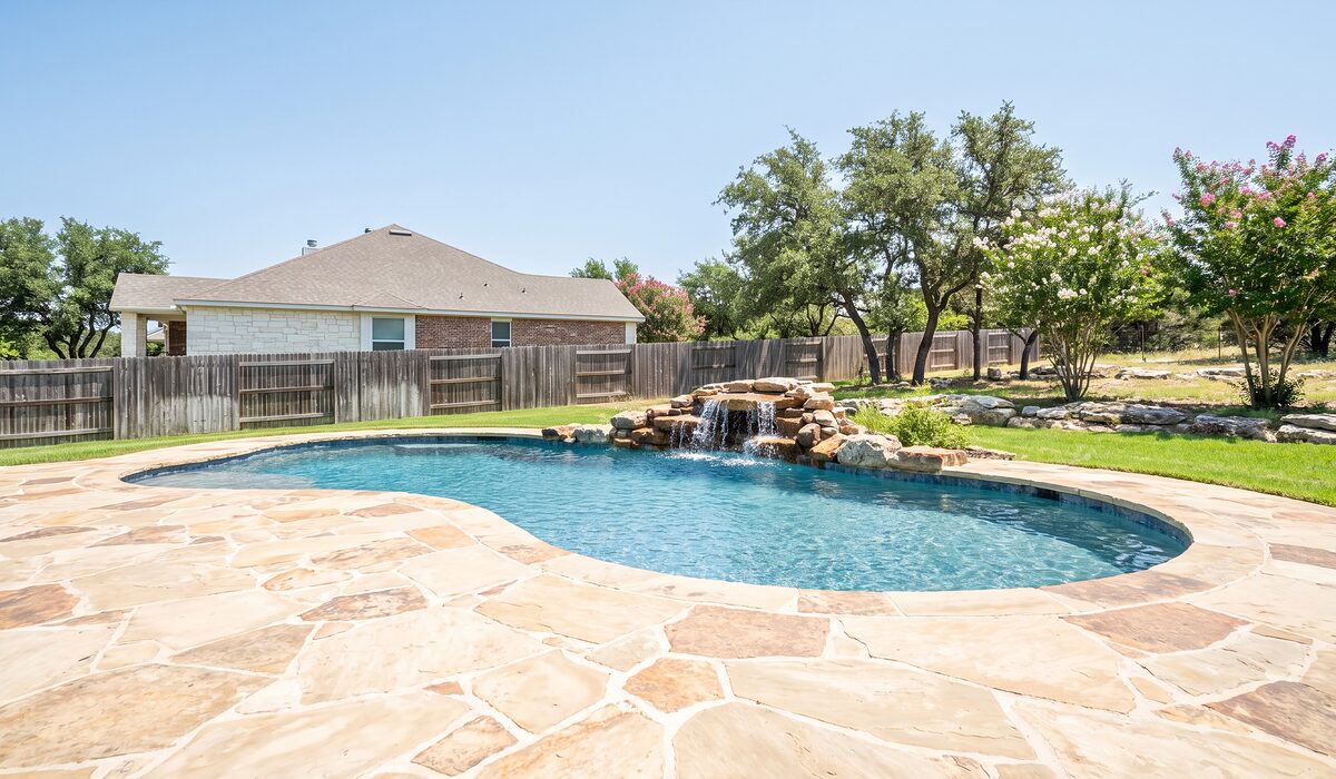 Newly built custom gunite pool with a travertine deck at a Texas home