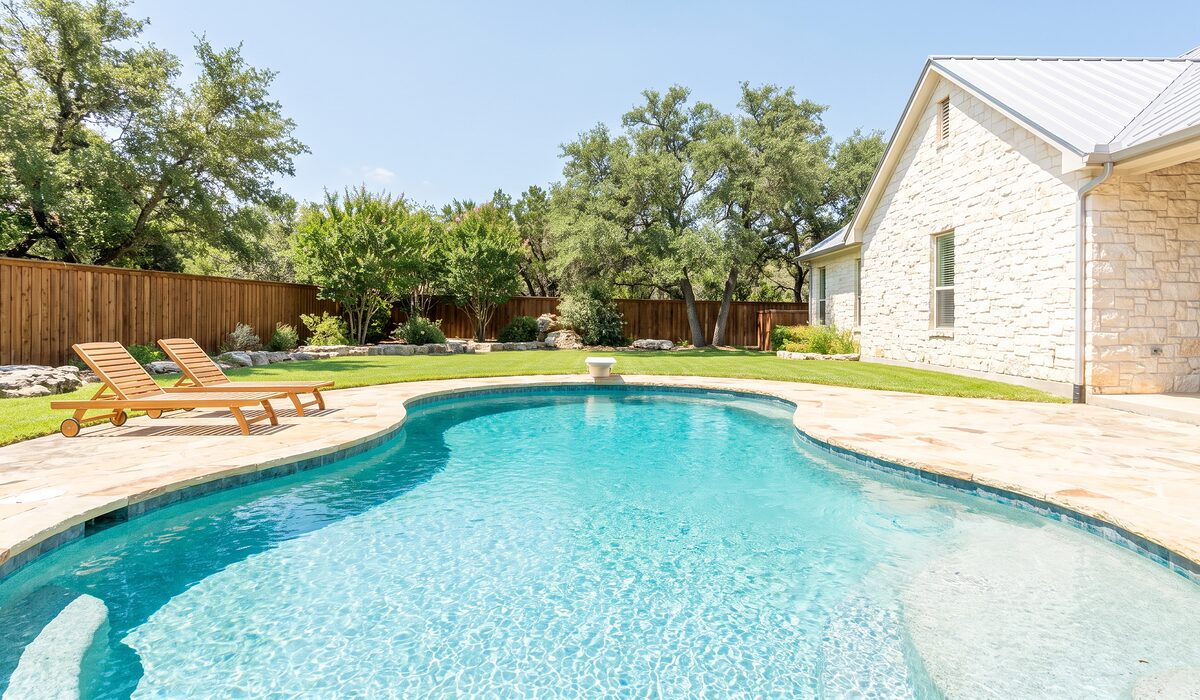 Sparkling backyard swimming pool at a Texas home on a sunny day