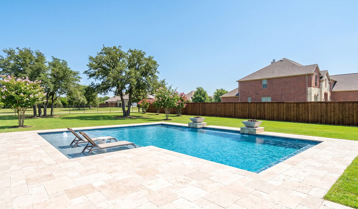 Newly built custom gunite pool with a travertine deck at a Texas home
