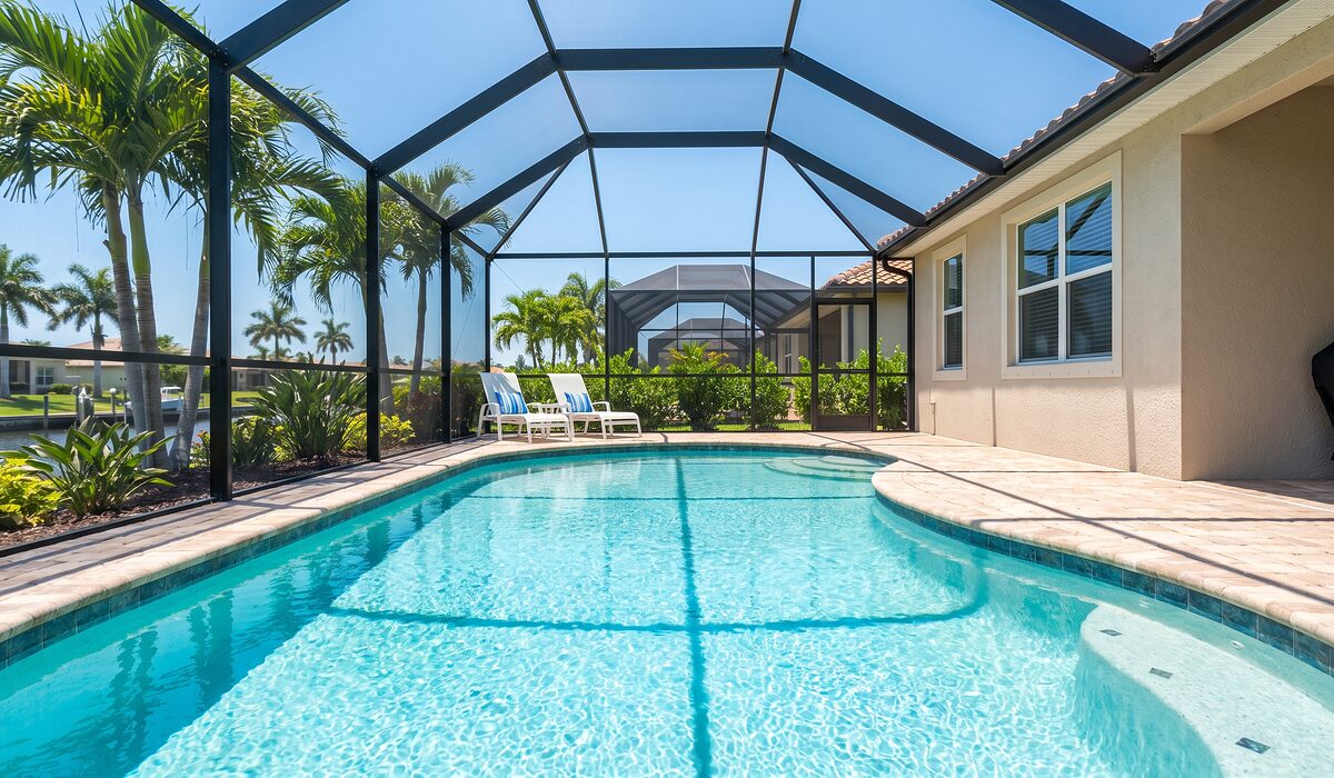 Sparkling backyard swimming pool inside a screened lanai at a Florida home