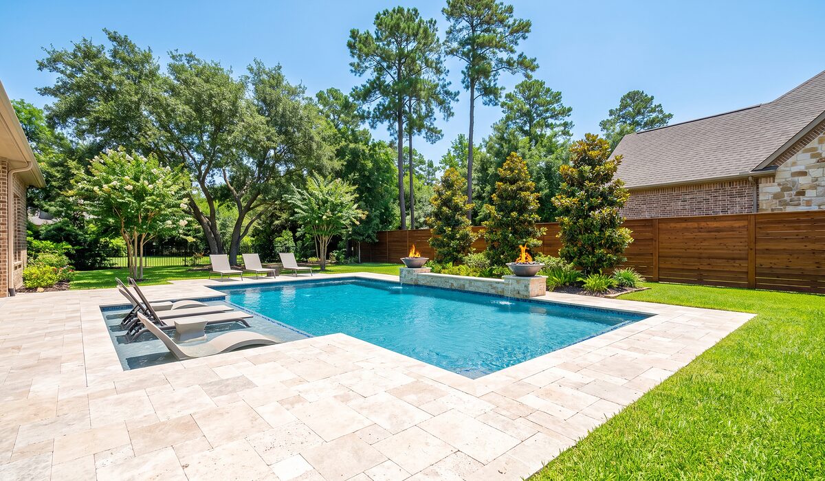 Newly built custom gunite pool with a travertine deck at a Texas home