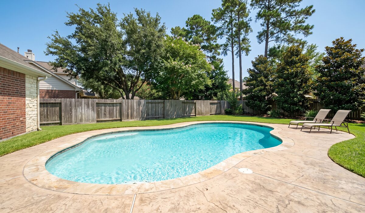 Sparkling backyard swimming pool at a Texas home on a sunny day