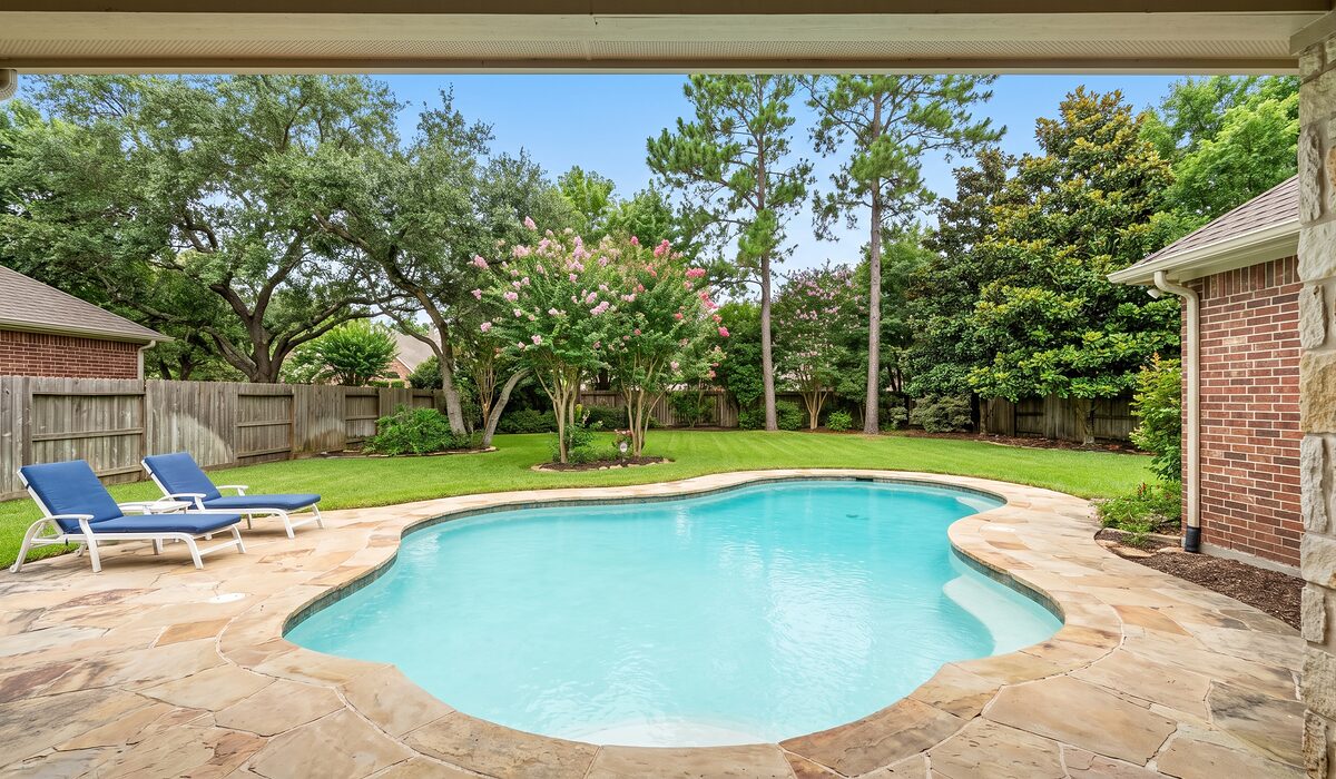 Sparkling backyard swimming pool at a Texas home on a sunny day