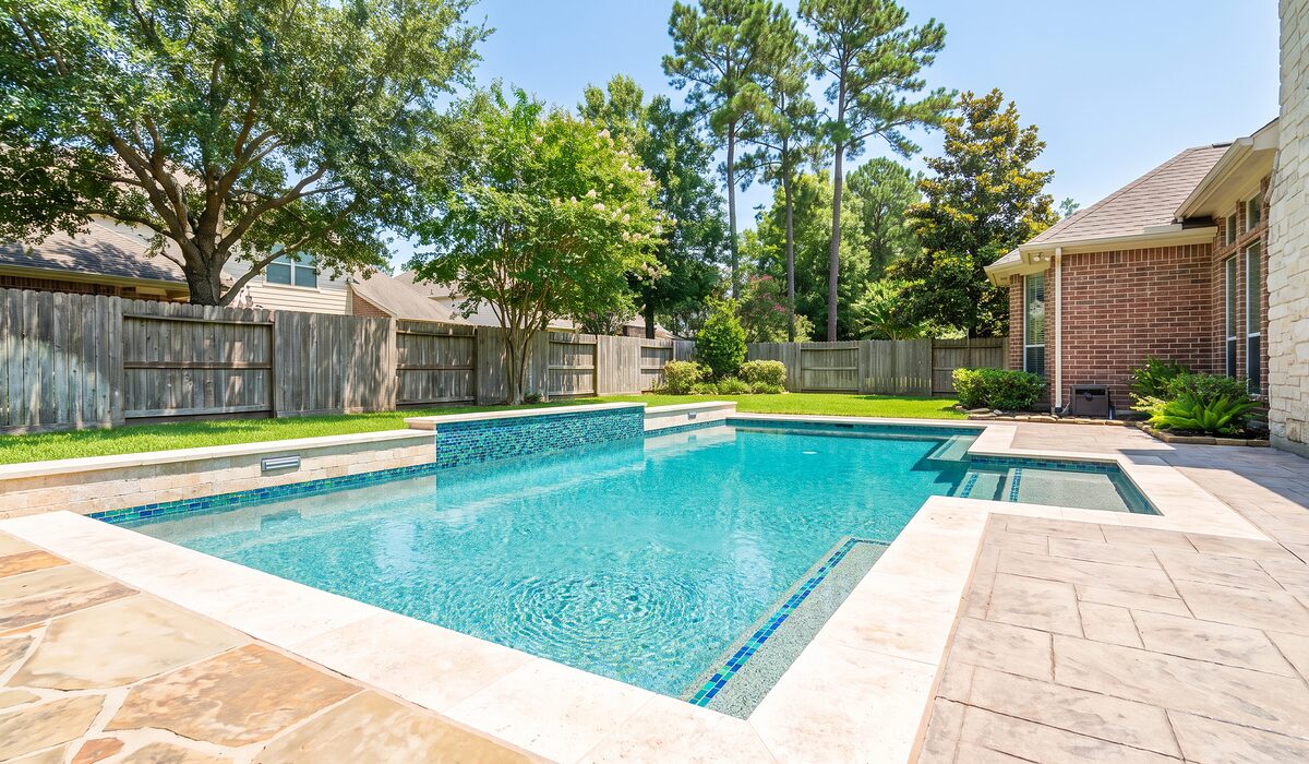 Remodeled swimming pool with new tile and coping at a Texas home