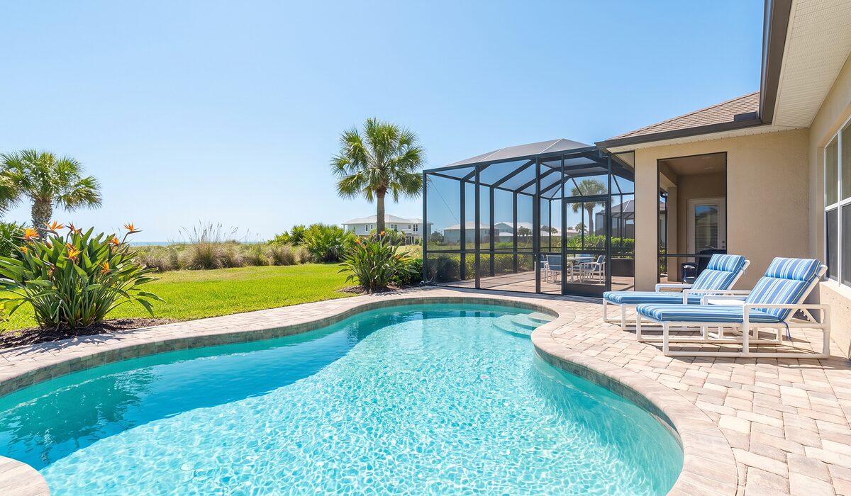 Sparkling backyard swimming pool inside a screened lanai at a Florida home