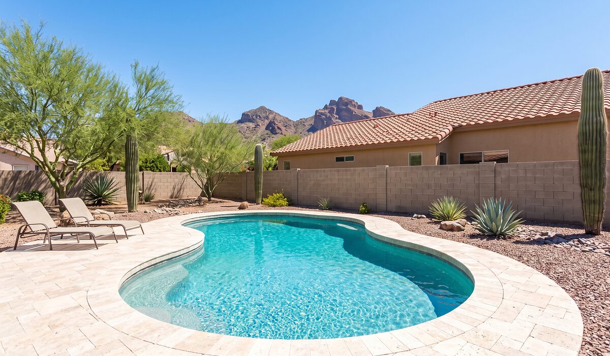 Sparkling backyard swimming pool with desert landscaping at an Arizona home