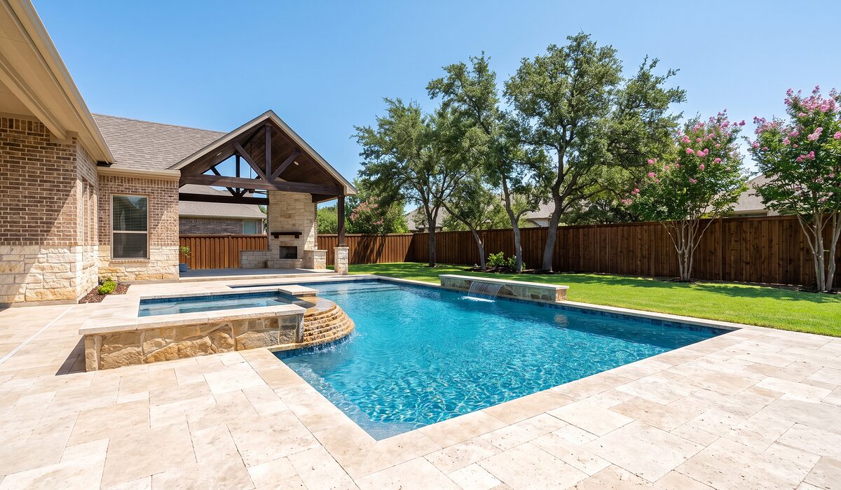 Newly built custom gunite pool with a travertine deck at a Texas home