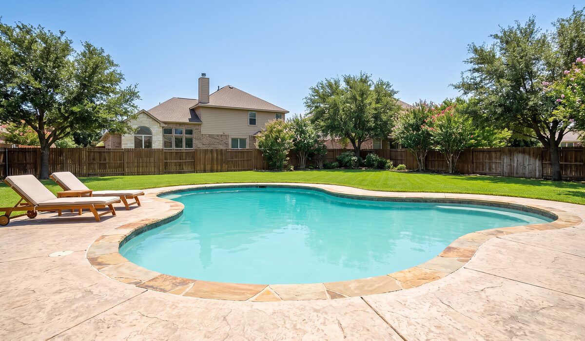 Sparkling backyard swimming pool at a Texas home on a sunny day