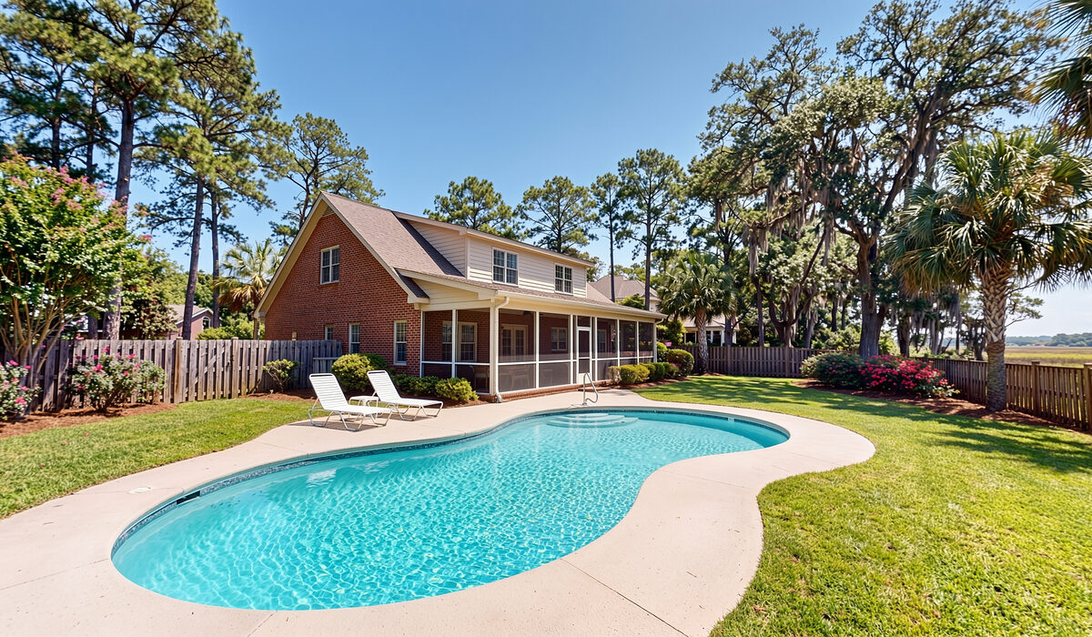 Sparkling backyard swimming pool under tall pines at a Georgia home